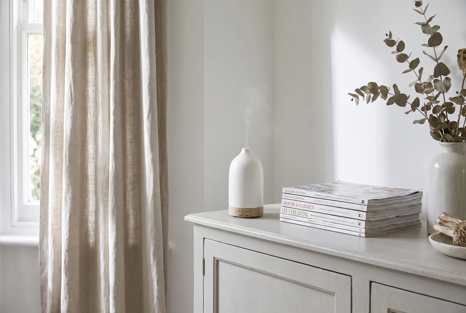 The White Company Electronic Diffuser producing a fine mist on a kitchen worktop
