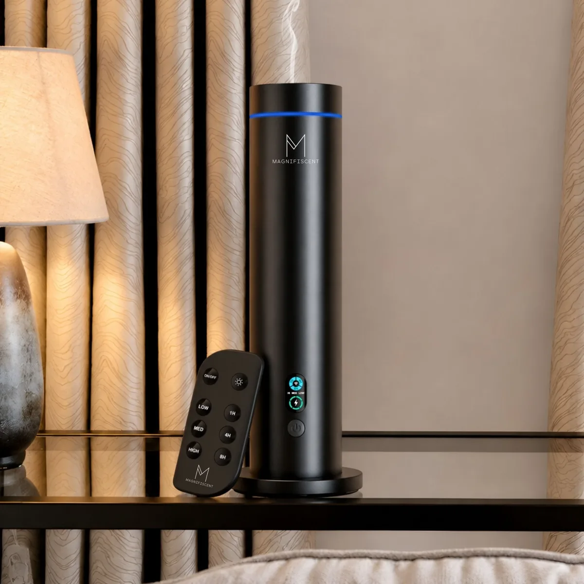 The NovaMist tower diffuser on a bedside table with its remote control