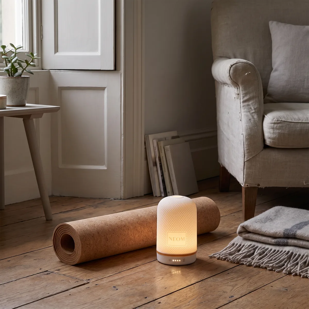 The Wellbeing Pod glowing beside a yoga mat in a living room corner